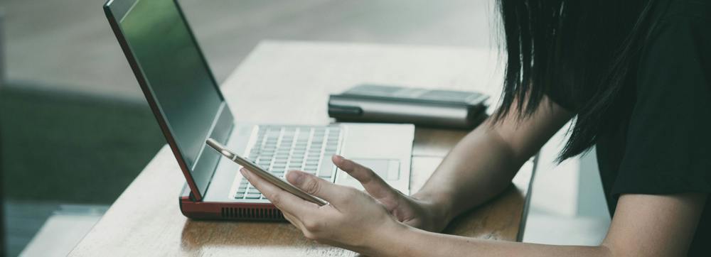 Person on the internet on their phone and computer