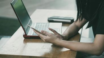Person on the internet on their phone and computer