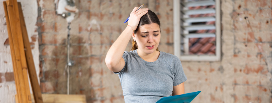 frustrated young woman with poor home renovation