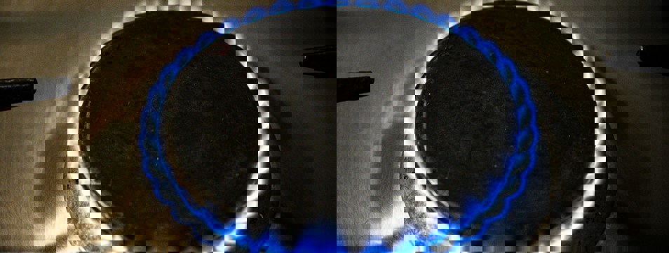 Gas ring lit with flickering blue flame