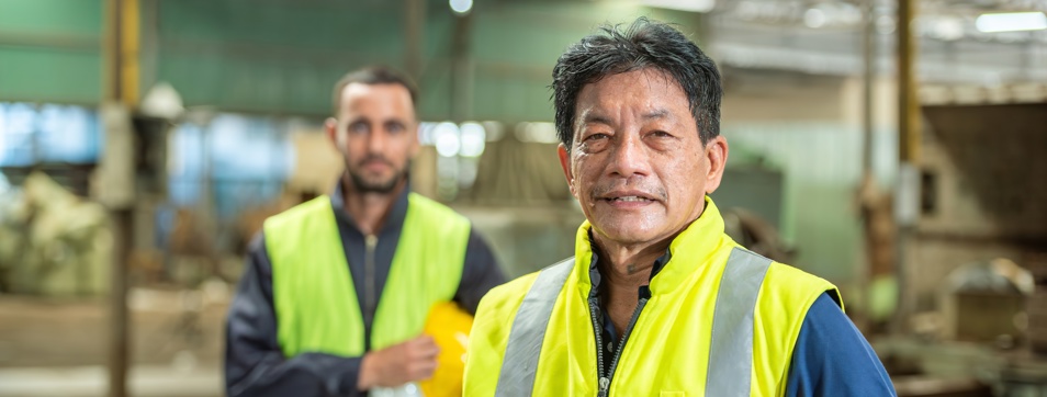an older tradesperson with a younger tradesperson