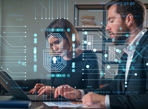 A woman and a man using computers, tech background