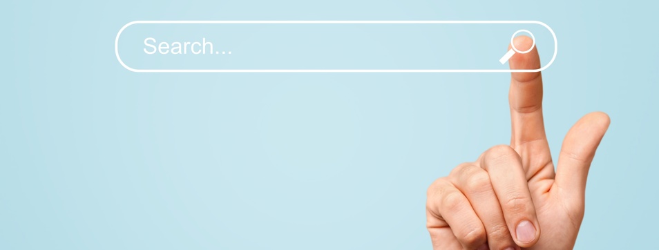 Hand of man touching a search icon