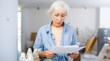 Upset homeowner evaluating documentation