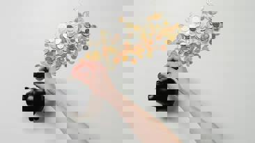 Person putting money in a piggybank