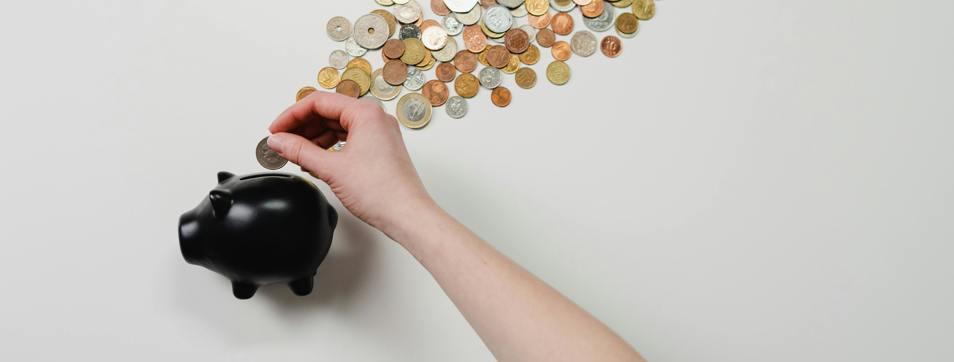 Person putting money in a piggybank