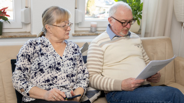 Senior couple reviewing documents at home