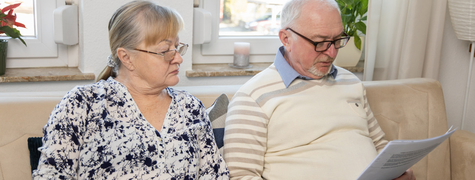 Senior couple reviewing documents at home
