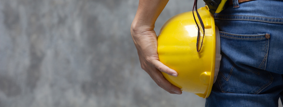 Construction Worker holding a hard hat