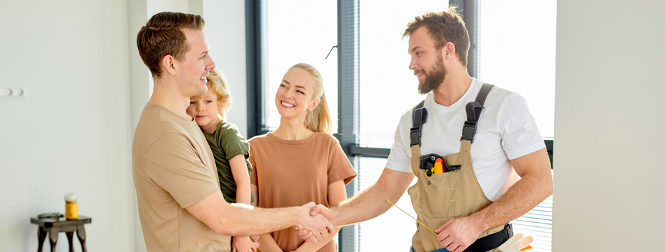 Homeowner and tradesperson shaking hands