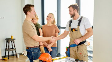 Homeowner and tradesperson shaking hands